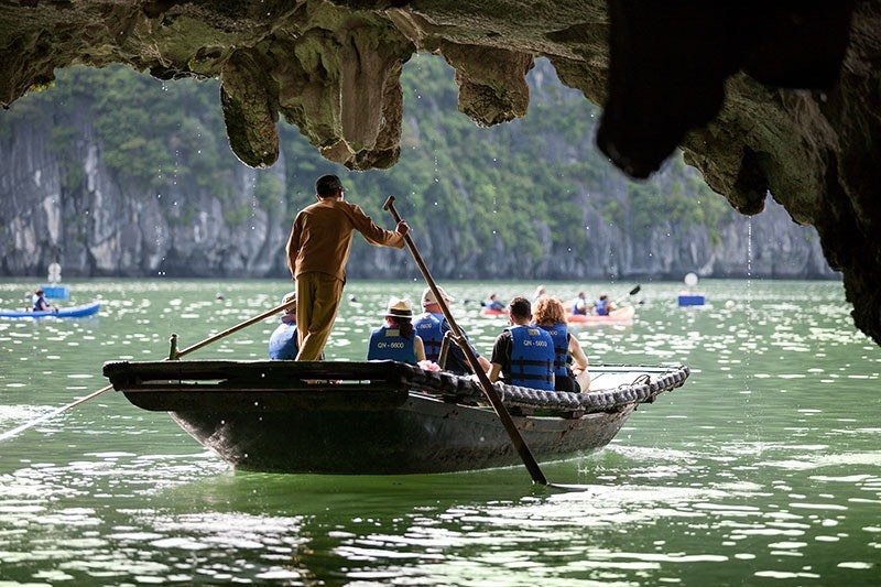 Take a bamboo boat tour for sightseeing in Luon Cave